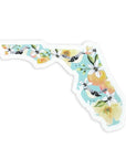 Florida shaped sticker with mockingbirds and oranges and orange blossoms on teal background
